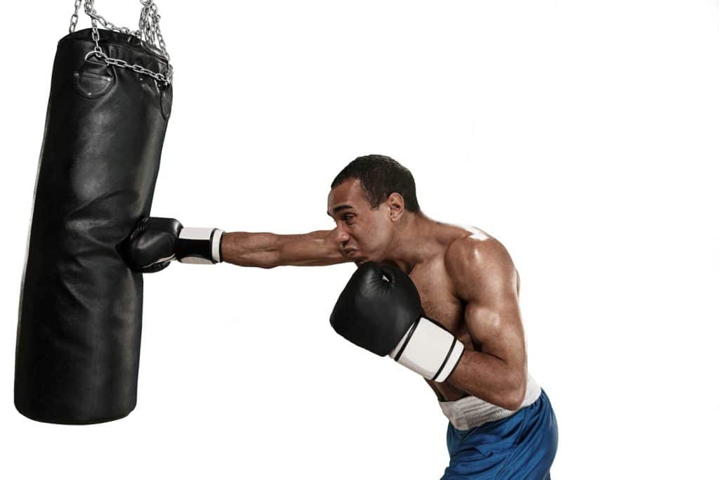 man showing strength hitting punching bag